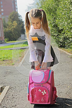The schoolgirl with a heavy satchel