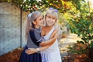 Schoolgirl hugs mom after school