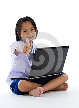 Schoolgirl with laptop and thumb up