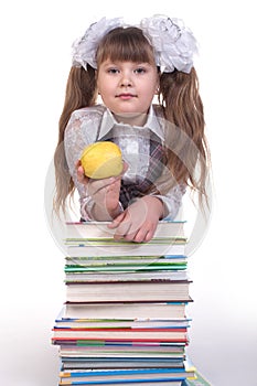 Schoolgirl leaning on a pile of books