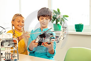 Schoolgirl looking at the helicopter made by her classmate.