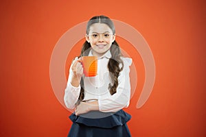 Schoolgirl with mug having tea break. Relax and recharge. Water balance. Enjoying tea before school classes. Drink