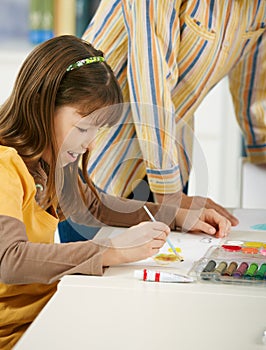 Schoolgirl painting in art class