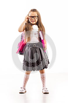 Schoolgirl with pink satchel in glasses holding