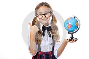 Schoolgirl points her finger at the globe. Learn geography.