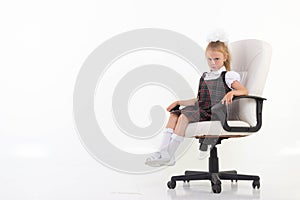 Schoolgirl proudly sits on a her chair