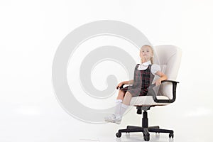 Schoolgirl proudly sits on a her chair