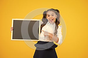 Schoolgirl pupil long hair informing you. School girl hold blank chalkboard copy space. Announcement and promotion