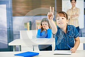 Schoolgirl raising hand