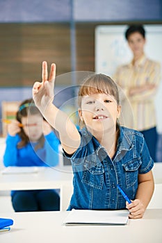 Schoolgirl raising hand