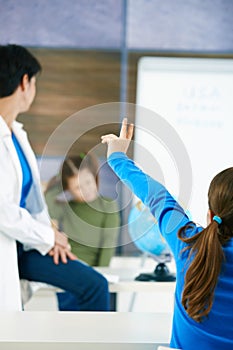 Schoolgirl raising hand