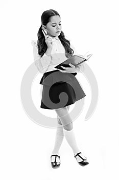 Schoolgirl read book isolated on white. Little child hold textbook with pen. Dedicated to study. Back to school. Home