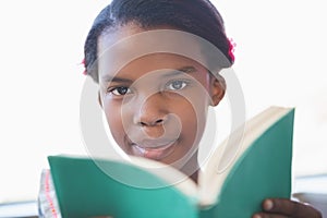 Schoolgirl reading book in library