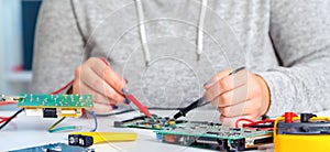 Schoolgirl repairing the electronic printed circuit board.Computer repair