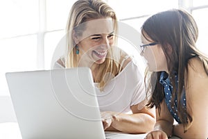 Schoolgirl researching online with the guidance of her teacher