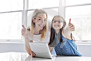 Schoolgirl researching online with the guidance of her teacher