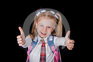 Schoolgirl showing thumbs up sign using both hands at the black