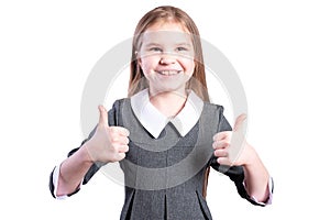 Schoolgirl shows thumbs up. Isolated on white background