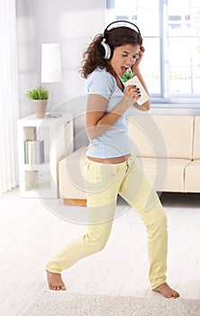 Schoolgirl singing at home