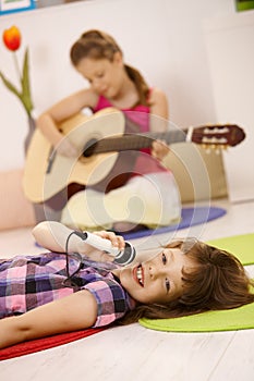 Schoolgirl singing into microphone