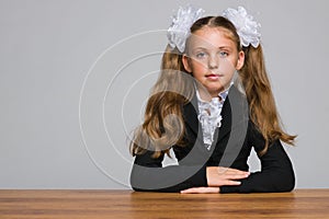 Schoolgirl sits at the desk