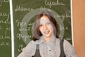 Schoolgirl standing at the blackboard