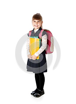 Schoolgirl is standing with folders in hands