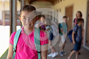 Schoolgirl standing in the schoolyard at elementary school