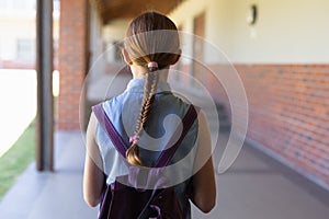 Schoolgirl standing in the schoolyard at elementary school