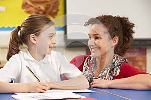 Schoolgirl Studying In Classroom With Teacher