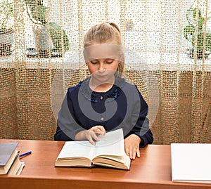 Schoolgirl studying and reading book at school