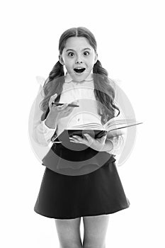 Schoolgirl with surprised look isolated on white. Little child hold book with pen. Back to school. Home schooling