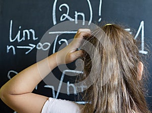 Schoolgirl thinks on the difficult task of mathematics