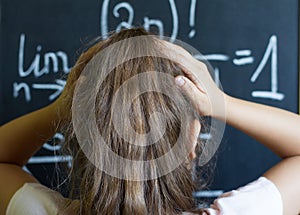 Schoolgirl thinks on the difficult task of mathematics