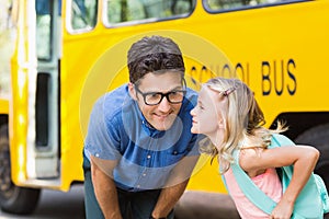 Schoolgirl about to kiss a teacher in front of school bus