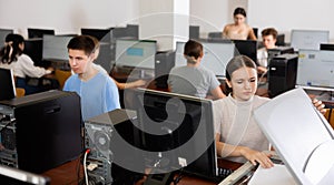 Schoolgirl uses a scanner in the computer class of school