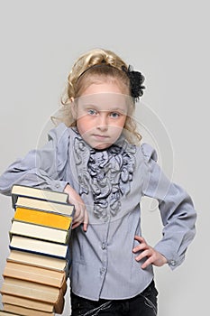 Schoolgirl with a very high stack of books