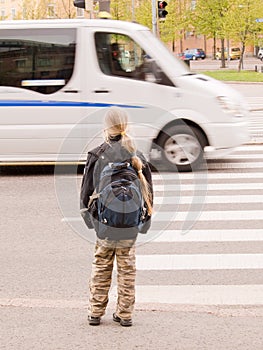 Schoolgirl waiting for the traffic light