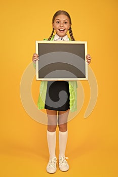 Schoolgirl wear raincoat hold blank chalkboard copy space. Waterproof fabric for comfort. Rainproof accessory