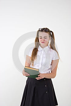 Schoolgirl in white blouse with glasses hate homework