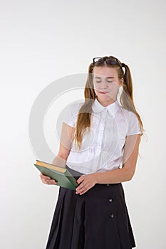 Schoolgirl in white blouse with glasses hate homework