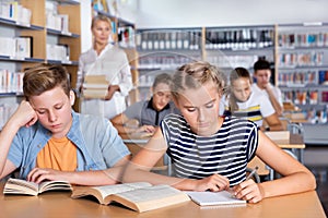 Schoolgirl writing lesson in classroom