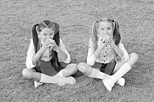 Schoolgirls eating apples relaxing schoolyard, healthy lunch concept