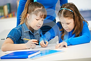 Schoolgirls learning in classroom photo