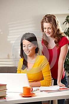 Schoolgirls looking at laptop