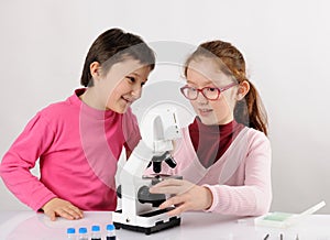 Schoolgirls with modern microscope
