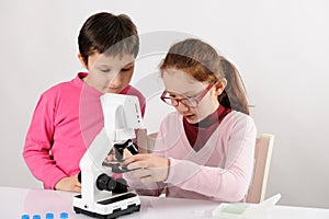 Schoolgirls with modern microscope