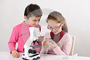Schoolgirls with modern microscope