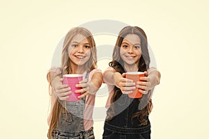 Schoolgirls with mugs having tea break. Relax and recharge. Water balance concept. Enjoying tea together. Sisters or