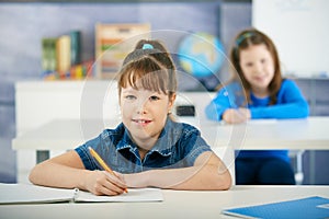 Schoolgirls in primary school classroom photo